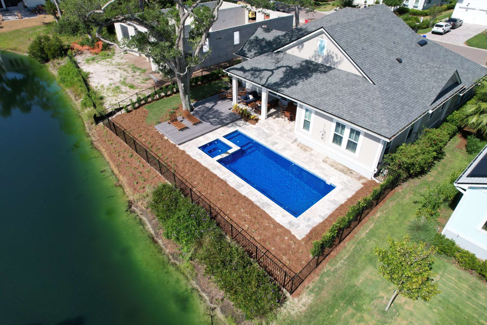 Completed residential swimming pool with surrounding patio