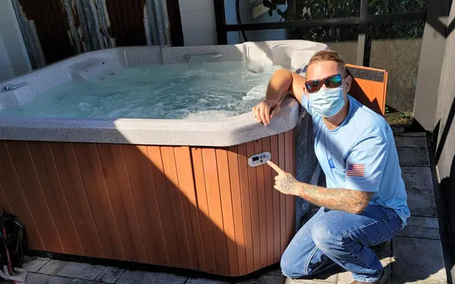 Pool professional inspecting residential pool equipment